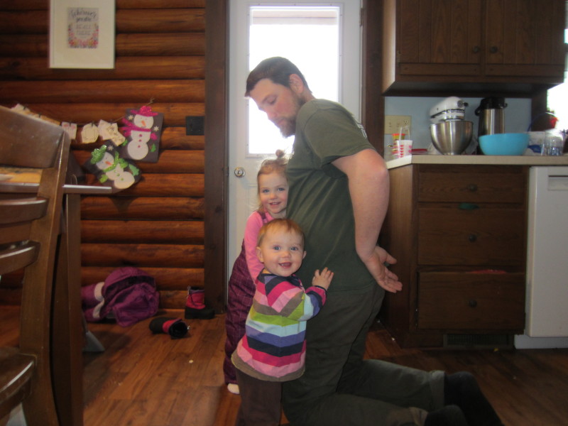 Daddy helping get snow gear on