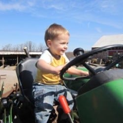 Growing Kids and Planting Trees If it were up to him-- he'd sit on that tractor all day long!