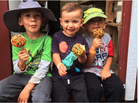 Cute kids eating caramel apples