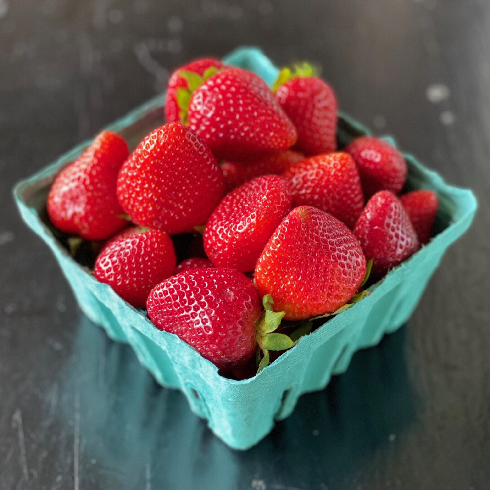 green carton of fresh strawberries